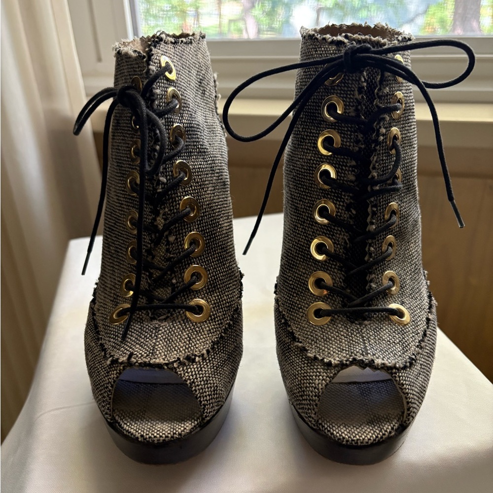 Stuart Weitzman lace up prep toe booties.